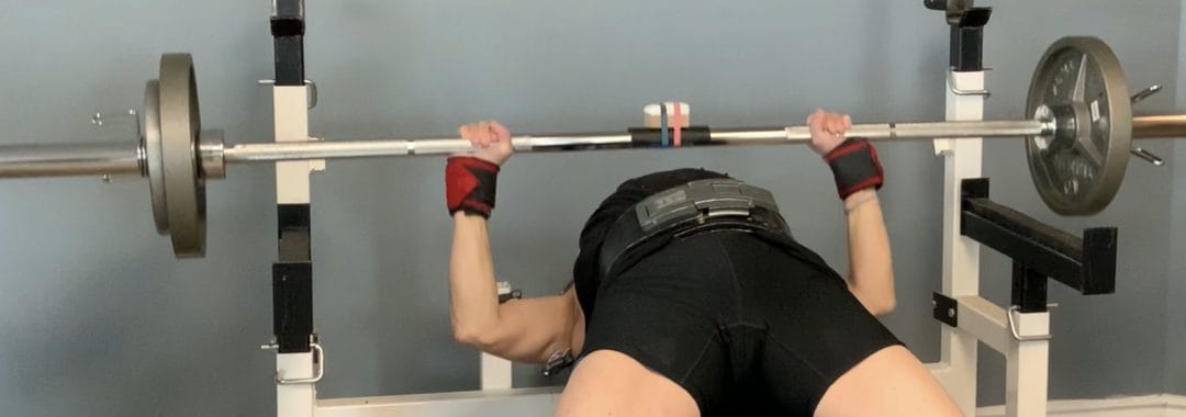 A powerlifter performing the bench press during an EMG Analysis