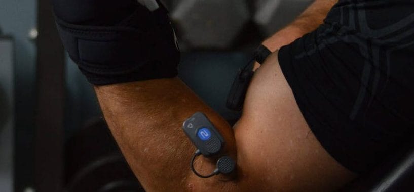 Performing a preacher curl with EMG sensors on the long head of the biceps and brachioradialis